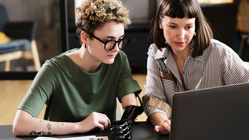 People sitting together with laptop