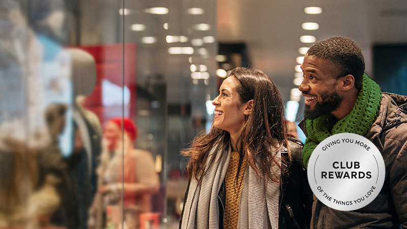Couple window shopping and icon stating Club Rewards giving you more of the things you love
