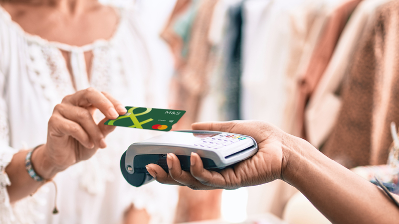 Person swiping Credit Card over payment device