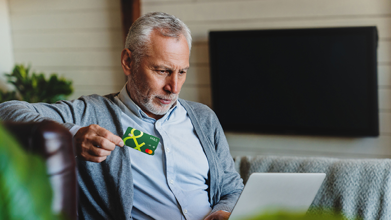 Person sitting holding Credit Card
