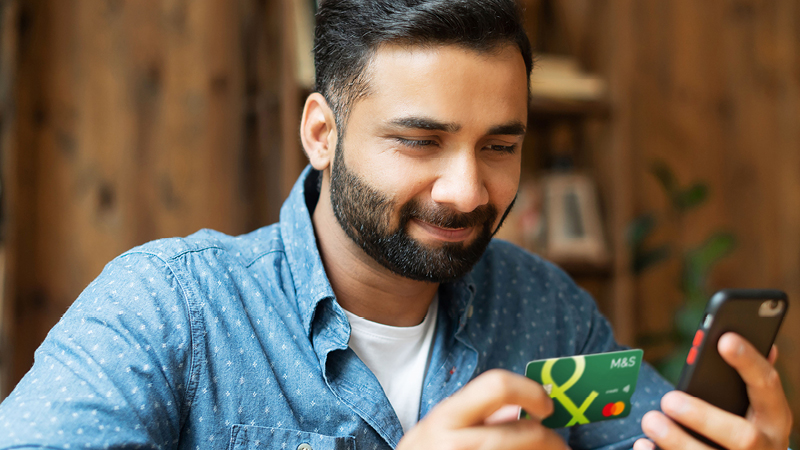 Person holding Credit Card and mobile