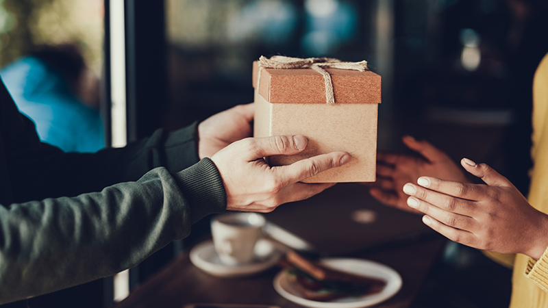 Two people exchanging a gift