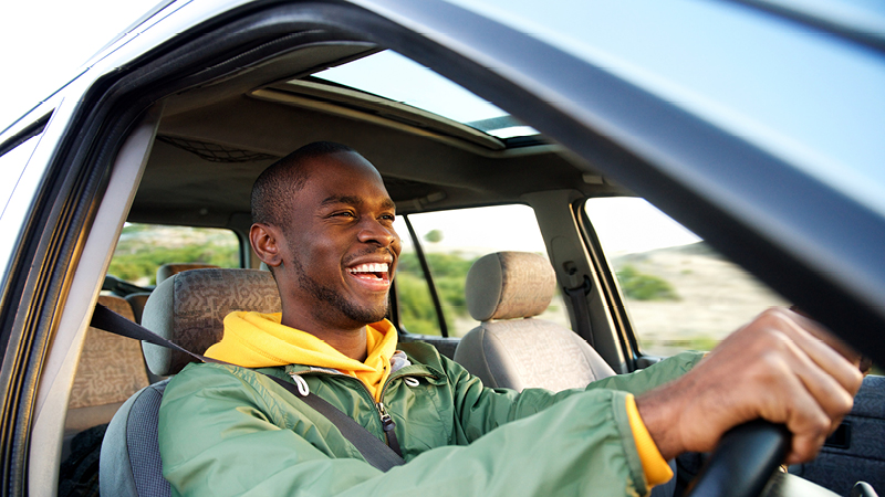 Smiling person driving car