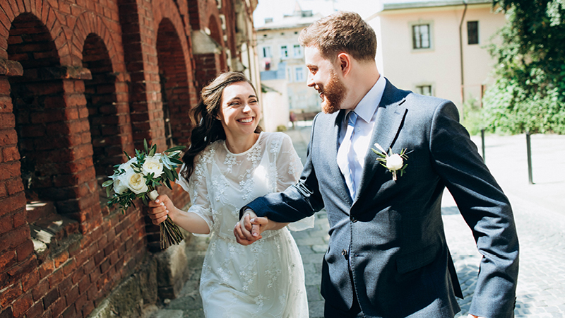 Couple in wedding outfits on sunny day