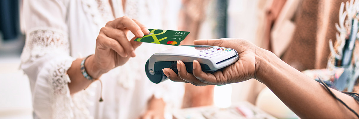 Person swiping Credit Card over payment device