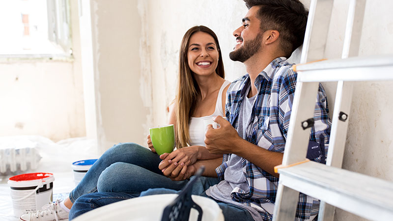 Couple enjoying painting their home