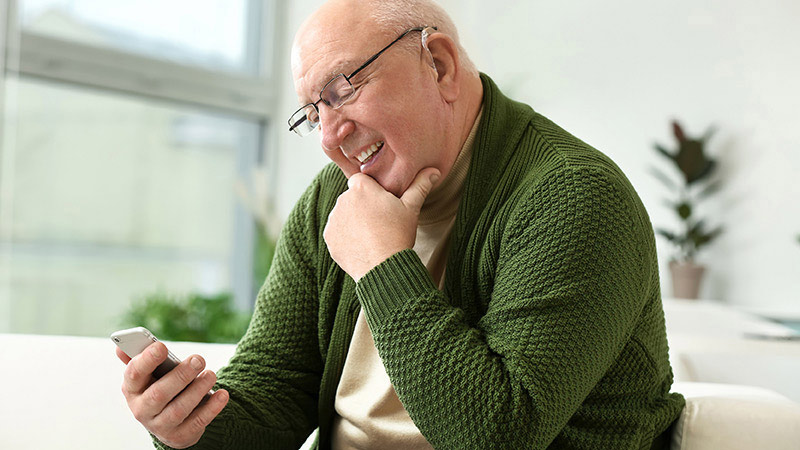 Mature person holding phone