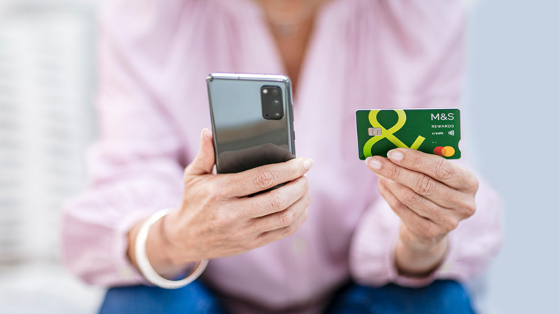 Person holding mobile and Credit Card
